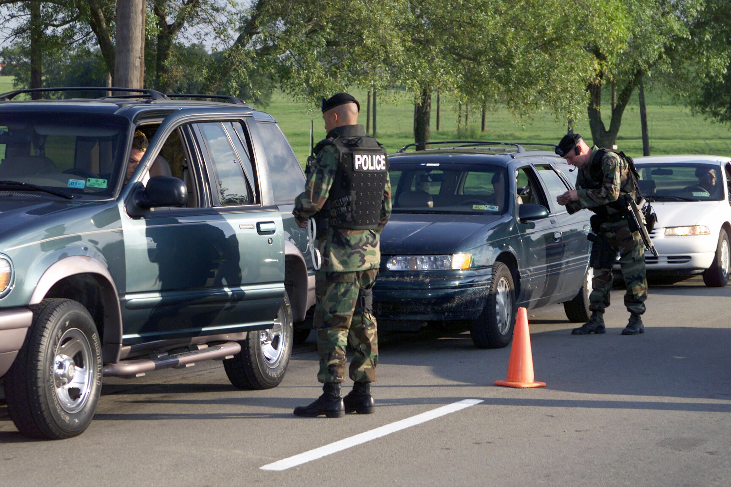 Soldiers of the 89th Military Police Brigade check motorists' identification at the main gate of Fort Hood, Texas, in 2001.